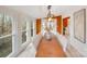 Sun-filled dining room with wooden table, access to sunroom, and hardwood floors at 11270 Widenhouse Rd, Midland, NC 28107