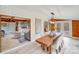 Bright dining area with wooden table and access to living room and sunroom at 11270 Widenhouse Rd, Midland, NC 28107