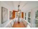 Dining room with a large wooden table and sunroom access at 11270 Widenhouse Rd, Midland, NC 28107