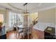 Bright dining room featuring a wooden table, chandelier, and hardwood floors at 114 Runningdeer Dr, Mooresville, NC 28117