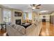 Open living room with hardwood floors, fireplace and kitchen view at 114 Runningdeer Dr, Mooresville, NC 28117