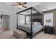 Main bedroom with a large four poster bed and ensuite bathroom access at 114 Runningdeer Dr, Mooresville, NC 28117