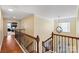 Upstairs hallway with hardwood floors and elegant railing at 114 Runningdeer Dr, Mooresville, NC 28117