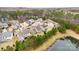 Aerial view of home and neighborhood with pond and surrounding trees at 11519 Sweet Birch Ln, Charlotte, NC 28278