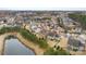 Aerial view of house and neighborhood, showcasing a pond and surrounding homes at 11519 Sweet Birch Ln, Charlotte, NC 28278