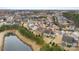 Aerial view of neighborhood with pond, mature trees, and green lawns at 11519 Sweet Birch Ln, Charlotte, NC 28278