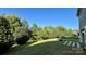 Lush backyard featuring a stone path to a fire pit near a tranquil pond at 11519 Sweet Birch Ln, Charlotte, NC 28278