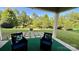 Serene backyard with a fire pit, lush lawn, and a peaceful pond at 11519 Sweet Birch Ln, Charlotte, NC 28278
