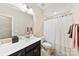 Well-lit bathroom with a large mirror, neutral walls, and a shower-tub combo at 11519 Sweet Birch Ln, Charlotte, NC 28278