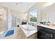 Relaxing bathroom with a soaking tub beneath a large window and dual vanities at 11519 Sweet Birch Ln, Charlotte, NC 28278