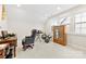 Well-lit bedroom with drumset, wooden accent cabinet, and carpeted floor at 11519 Sweet Birch Ln, Charlotte, NC 28278