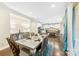 Elegant dining room with modern table and chairs, adjacent to kitchen at 11519 Sweet Birch Ln, Charlotte, NC 28278