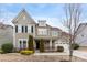 Two-story house with gray siding, black shutters, and a landscaped yard at 11519 Sweet Birch Ln, Charlotte, NC 28278