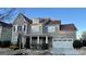 Two-story home with gray siding, white trim, and a three-car garage at 11519 Sweet Birch Ln, Charlotte, NC 28278