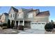 Two-story house with gray siding, white columns, and a two-car garage at 11519 Sweet Birch Ln, Charlotte, NC 28278