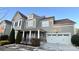 Two-story home with gray siding, white trim, and a three-car garage at 11519 Sweet Birch Ln, Charlotte, NC 28278