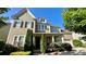 Attractive two-story home features a two-car garage, manicured landscaping, and a covered front porch at 11519 Sweet Birch Ln, Charlotte, NC 28278