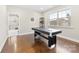 Bright game room with hardwood floors and space for recreation by a window at 11519 Sweet Birch Ln, Charlotte, NC 28278