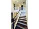 Elegant staircase with wood treads and white railings at 11519 Sweet Birch Ln, Charlotte, NC 28278