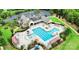 Aerial view of the community pool with blue water, surrounded by seating, playground, and lush landscaping at 11519 Sweet Birch Ln, Charlotte, NC 28278
