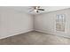 Spacious bedroom with neutral wall paint, ceiling fan, and carpeted floor at 116 Westover Ave, Kannapolis, NC 28081