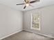 Bright bedroom with carpet, ceiling fan, and large window at 116 Westover Ave, Kannapolis, NC 28081