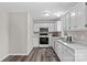 White kitchen with stainless steel appliances and vinyl flooring at 116 Westover Ave, Kannapolis, NC 28081