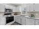 White kitchen with stainless steel appliances and a window at 116 Westover Ave, Kannapolis, NC 28081