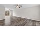 Spacious living room with gray vinyl flooring and ceiling fan at 116 Westover Ave, Kannapolis, NC 28081