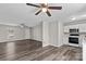 Open living room and kitchen with grey vinyl flooring and ceiling fans at 116 Westover Ave, Kannapolis, NC 28081