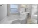 Main bathroom with corner soaking tub and double vanity at 11615 Kingsley View Dr, Charlotte, NC 28277