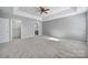 Spacious carpeted bedroom with ceiling fan and walk-in closet at 11615 Kingsley View Dr, Charlotte, NC 28277