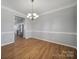 Bright dining room features hardwood floors and a chandelier at 11615 Kingsley View Dr, Charlotte, NC 28277