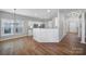 Open concept dining room with hardwood floors and breakfast bar at 11615 Kingsley View Dr, Charlotte, NC 28277