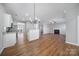 Open concept dining area with hardwood floors and chandelier at 11615 Kingsley View Dr, Charlotte, NC 28277