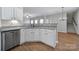 White kitchen with granite countertops and stainless steel dishwasher at 11615 Kingsley View Dr, Charlotte, NC 28277