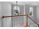 Bright landing with wood railing, ceiling fan, and arched window at 11615 Kingsley View Dr, Charlotte, NC 28277