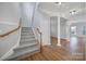 Staircase with gray carpeting and wooden railing at 11615 Kingsley View Dr, Charlotte, NC 28277