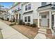 Townhome exterior showcasing gray and white siding, a stone foundation, and landscaping at 12515 Bryton Ridge Pkwy, Huntersville, NC 28078