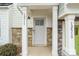 Gray front door with a glass panel and white columns on a townhome at 12515 Bryton Ridge Pkwy, Huntersville, NC 28078