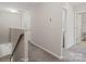 Upstairs hallway with carpet, laundry closet, and bathroom access at 12515 Bryton Ridge Pkwy, Huntersville, NC 28078