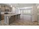 Modern kitchen with granite countertops, gray cabinetry, and an island at 12515 Bryton Ridge Pkwy, Huntersville, NC 28078