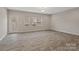 Spacious living room with vinyl plank flooring and sliding glass door at 12515 Bryton Ridge Pkwy, Huntersville, NC 28078