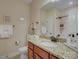 Bright bathroom with granite counters, decorative fixtures, and tiled shower at 1255 Restoration Dr, Waxhaw, NC 28173