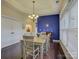 A dining room featuring a large window, hardwood floors, and a blue accent wall for an inviting atmosphere at 1255 Restoration Dr, Waxhaw, NC 28173