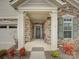 Inviting front porch with stone pillars and a cozy seating area, complemented by neat landscaping at 1255 Restoration Dr, Waxhaw, NC 28173