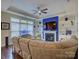 Well-lit living room with a fireplace, built-in shelves, and a comfortable sofa, ideal for entertaining guests at 1255 Restoration Dr, Waxhaw, NC 28173