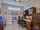 A well-lit home office space with built-in wooden desk and shelving at 1255 Restoration Dr, Waxhaw, NC 28173