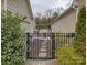 View of the cozy patio area, featuring comfortable seating and a pergola, accessible through a gated entrance at 1255 Restoration Dr, Waxhaw, NC 28173