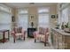 Bright sitting room featuring two colorful accent chairs, multiple windows, carpet and side tables at 1255 Restoration Dr, Waxhaw, NC 28173